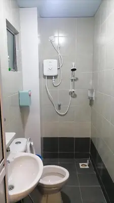 a bathroom with a shower and a toilet and a sink at Stoberi CekelatHomestay in Brinchang