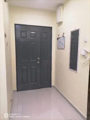 a black door in a room with a tile floor at Stoberi CekelatHomestay in Brinchang