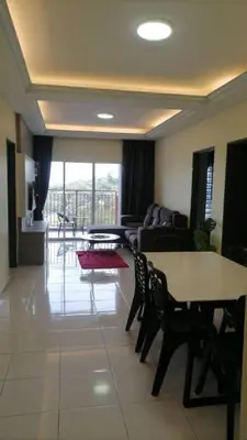 a living room with a couch and a table and chairs at Stoberi CekelatHomestay in Brinchang