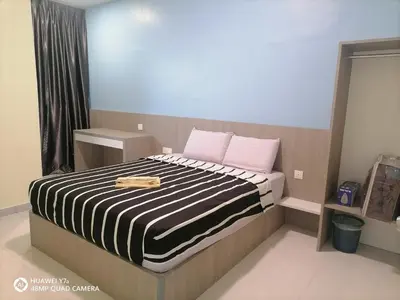 a bedroom with a bed with pink and black stripes at StoberiCekelatHomestaymuslim's in Brinchang