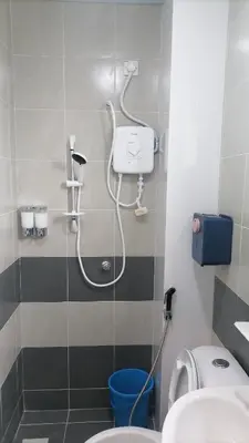 a bathroom with a shower with a toilet and a sink at StoberiCekelatHomestaymuslim's in Brinchang