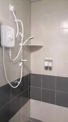 a shower in a bathroom with a shower head at StoberiCekelatHomestaymuslim's in Brinchang