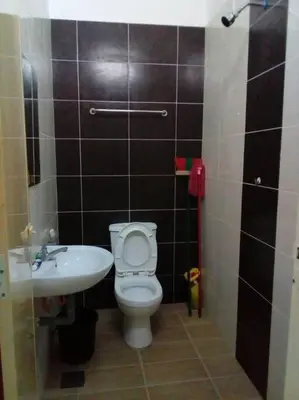 a bathroom with a toilet and a sink at Percutian Di Taiping & Bukit Merah Laketown in Kamunting