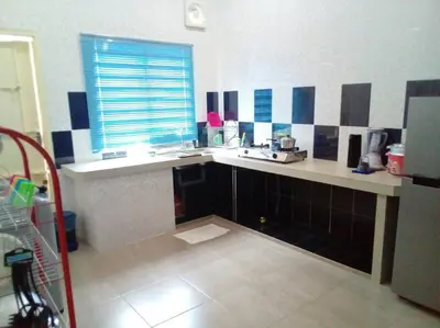a kitchen with a counter and a sink and a window at Percutian Di Taiping & Bukit Merah Laketown in Kamunting