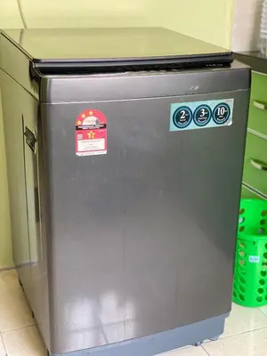 a gray refrigerator with stickers on the side of it at Homestay Desa Tikam batu in Sungai Petani