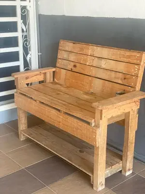 a wooden bench sitting on top of a floor at Homestay Desa Tikam batu in Sungai Petani