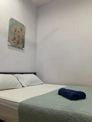 a bedroom with a bed with a blue towel on it at Homestay Desa Tikam batu in Sungai Petani