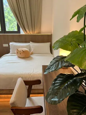 a bedroom with a bed and a table and a plant at 2-8pax Ipoh Nomado Onsen suites by Sunway Onsen Lost world of Tambun in Ipoh