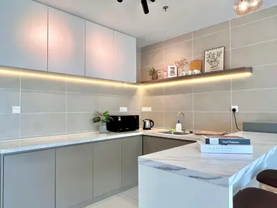 a kitchen with white cabinets and a counter top at 2-8pax Ipoh Nomado Onsen suites by Sunway Onsen Lost world of Tambun in Ipoh