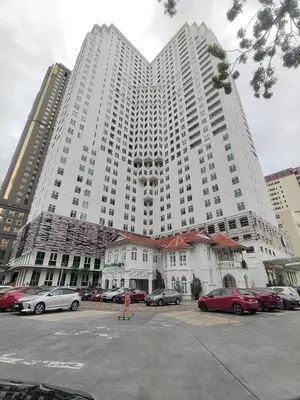 a large white building with cars parked in a parking lot at Exclusive Studio/15th/ 1~4pax/ Gurney/ Mansion One in George Town