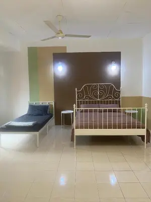 a bedroom with two beds and a ceiling at Comfy Sutera Seberang Jaya in Kampong Belah Dua