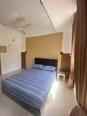 a bedroom with a large blue bed in a room at Comfy Sutera Seberang Jaya in Kampong Belah Dua