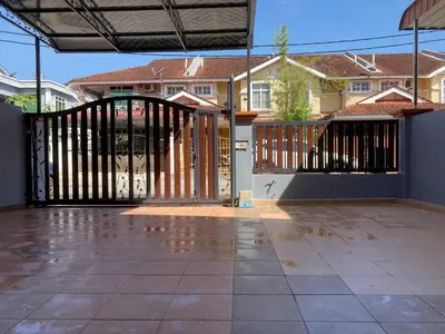 an open gate to a house with houses in the background at Comfy Sutera Seberang Jaya in Kampong Belah Dua