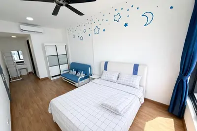 a bedroom with a bed and a blue chair at Tropicana 218 Macalister by CC in George Town