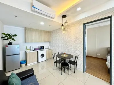 a kitchen and living room with a table and chairs at Tropicana 218 Macalister by CC in George Town
