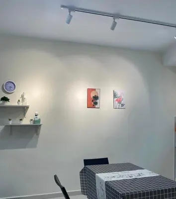 a white room with a bed and some pictures on the wall at Trails of Kampar in Kampar