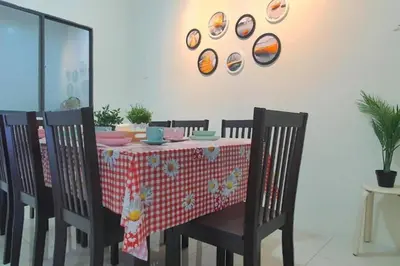 a dining room table with a red and white table cloth at Ipoh Meru Landed Semi D with Barbeque for 12 Pax in Ipoh