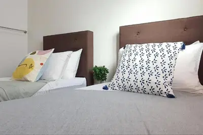 a bedroom with two beds and a pillow on it at Ipoh Meru Landed Semi D with Barbeque for 12 Pax in Ipoh