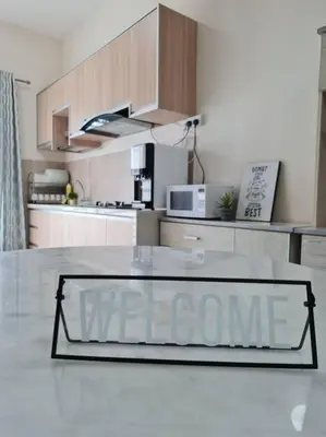 a glass sign on a table in a kitchen at 3Storey House 13Pax Family Suite in Bayan Lepas