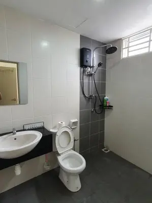 a bathroom with a toilet and a sink at 3Storey House 13Pax Family Suite in Bayan Lepas
