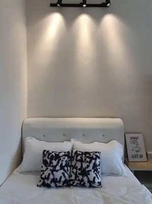 a white bed with two pillows on top of it at 3Storey House 13Pax Family Suite in Bayan Lepas
