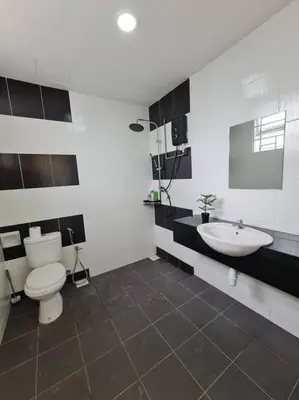 a bathroom with a white toilet and a sink at 3Storey House 13Pax Family Suite in Bayan Lepas