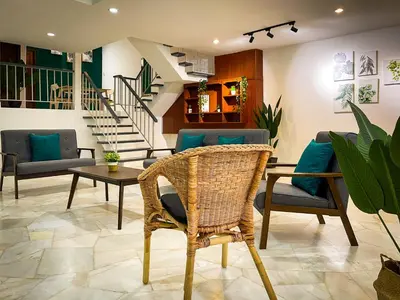 a living room with chairs and a table and stairs at Lake View 53 Heritage 4BR by LOUIS in Taiping