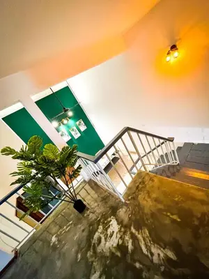 a house with a plant in the middle of a staircase at Lake View 53 Heritage 4BR by LOUIS in Taiping