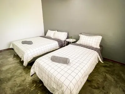 two beds with pillows in a room at Lake View 53 Heritage 4BR by LOUIS in Taiping
