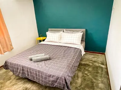 a bedroom with a bed with a purple blanket at Lake View 53 Heritage 4BR by LOUIS in Taiping