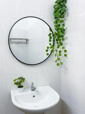 a bathroom sink with a mirror and a plant at Lake View 53 Heritage 4BR by LOUIS in Taiping
