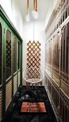 a wine tasting room with a chair and a mat at IPOH AGONG HOMESTAY by ONE LIFE FOUR SEASON GUESTHOUSE in Ipoh