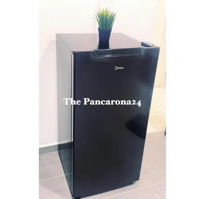 a black stand with a potted plant on it at The Pancarona24 Homestay forMuslim in Ipoh
