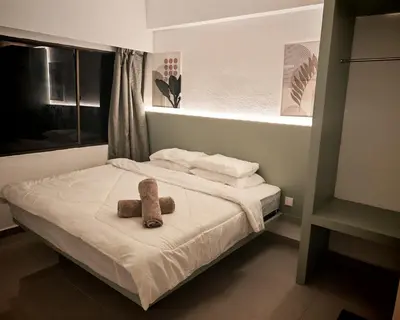 a bedroom with a bed with two teddy bears on it at Sri Sayang Home Stay in George Town