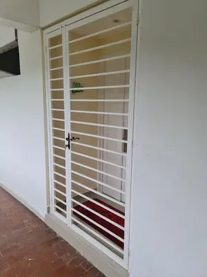 a room with a door with blinds on it at Sri Sayang Home Stay in George Town