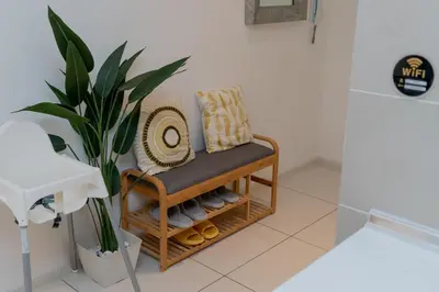 a bench with pillows and a plant in a bathroom at Ipoh Tambun Lost World Sunway Onsen Suite 2R 8Pax Mira Theme Park View in Ipoh