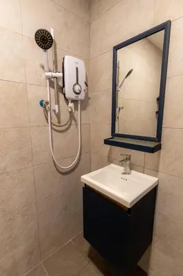 a bathroom with a shower and a sink and a mirror at 15Px 5BR V Jaccuzi Spa n KTV n Pool Table At Georgetown, USM n Lam Wah Ee Hospital -Kids pool no more in Gelugor