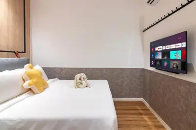a teddy bear sitting on a bed in a room at Bagan Suite in Butterworth