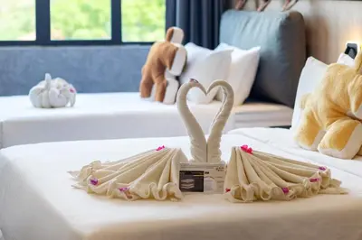 a hotel room with two swans on a bed at Bagan Suite in Butterworth