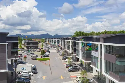 a city street with cars parked in a parking lot at Wellesley Hotel in Simpang Ampat