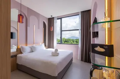 a hotel room with a bed and a window at Wellesley Hotel in Simpang Ampat
