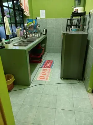 a kitchen with a sink and a refrigerator at HOMESTAY JANNATI TAMBUN in Tambun