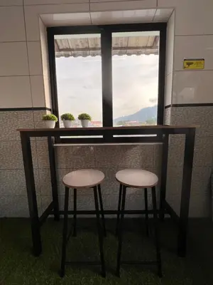 a table and two stools in front of a window at Room1#IG theme Bargainous#Shared Bathroom#3pax#2min Kek Lok Si in Ayer Itam