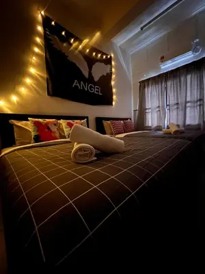 a bedroom with a large bed with a sign on the wall at Room2#IG theme Bargainous#Shared Bathroom#4pax#2min Kek Lok Si in Ayer Itam
