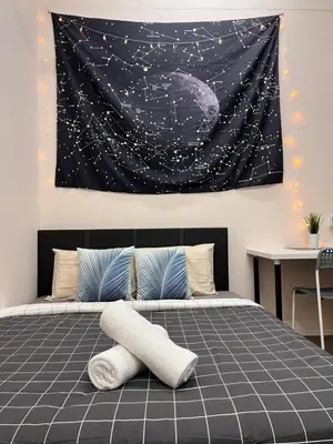 a bedroom with a bed with a painting on the wall at Room3#IG theme Bargainous#Shared Bathroom#2pax#2min Kek Lok Si in Ayer Itam