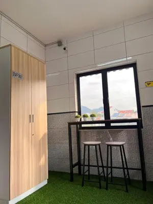 a table and two stools in a room with a window at Room3#IG theme Bargainous#Shared Bathroom#2pax#2min Kek Lok Si in Ayer Itam
