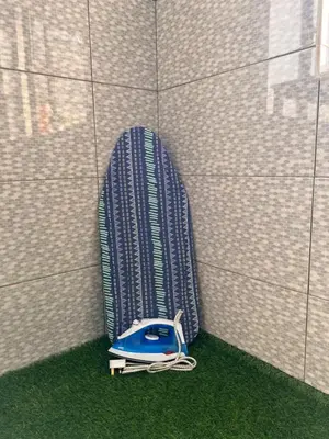 a blue phone sitting on the grass next to a wall at Room3#IG theme Bargainous#Shared Bathroom#2pax#2min Kek Lok Si in Ayer Itam