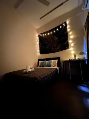 a bedroom with a bed with lights on the wall at Room3#IG theme Bargainous#Shared Bathroom#2pax#2min Kek Lok Si in Ayer Itam