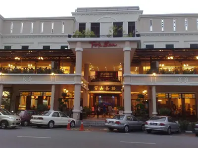 a large building with cars parked in front of it at Dim Sum Homestay in Ipoh
