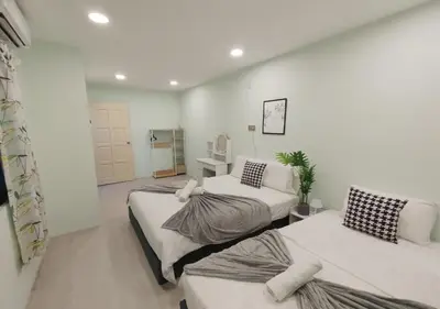 a bedroom with two beds in a room at Dim Sum Homestay in Ipoh